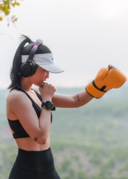 mulher com luvas de boxe e fones de ouvido